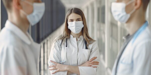 Diverse group of medical professionals in discussion at a hospital.