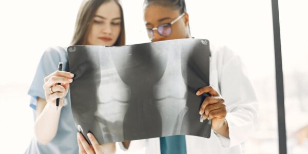 Surgeon reviewing 3D printed model of a foot joint implant.